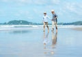Asian Lifestyle senior couple running on the beach happy and relax time. Royalty Free Stock Photo